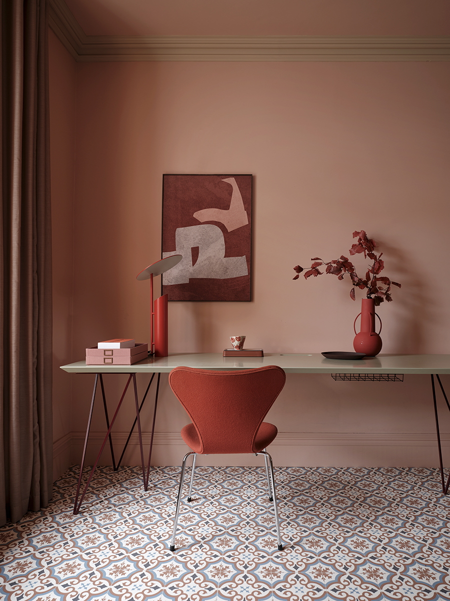 terracotta living room with Moroccan style vinyl flooring and a red home office corner